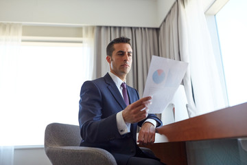 businessman with papers working at hotel room