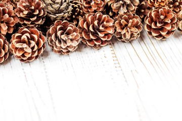 Cones on a white wooden background. Concept Happy Christmas, New Year, holiday, winter.