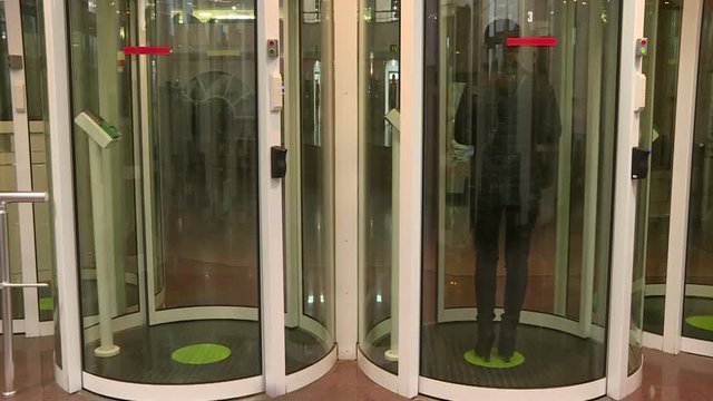 Employees pass through the entrance of the secret enterprise.The security system at the entrance .