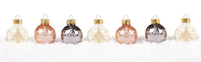 Christmas border of shiny white and gold baubles resting in snow over a white background