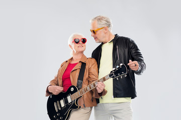 senior couple in sunglasses with electric guitar