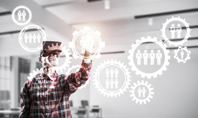 Guy wearing checked shirt and virtual mask demonstrating some em