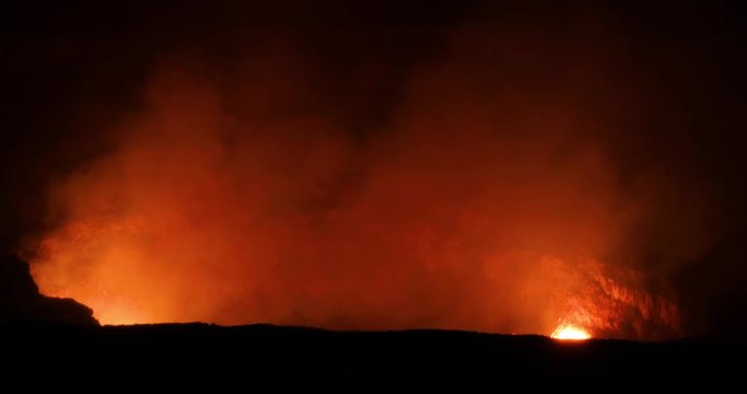 Kilauea crater Volcano National Park night lava eruptions night Hawaii. Most active volcano in the USA. Smoke, steam, gasses. Big Island Volcano National Park. Tourism destination for science, explora