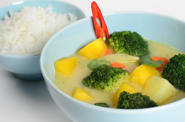 Traditional Thai hot dish of potato, pumpkin, broccoli, green peas and chili in a bowl with rice
