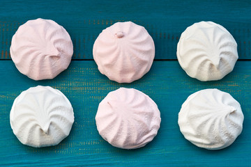 heap of marshmallow on blue wooden background