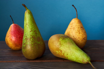 Pears on a rustic wooden kitchen table. Autumn concept