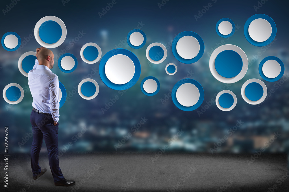 Poster businessman in front of a wall with empty app interface made of blue button displayed on a interface
