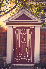 forged metallic entrance wicket with concrete pillars