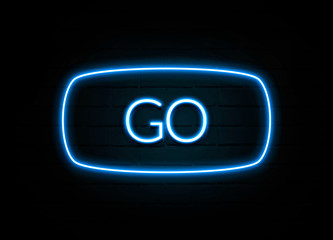 Go  - colorful Neon Sign on brickwall