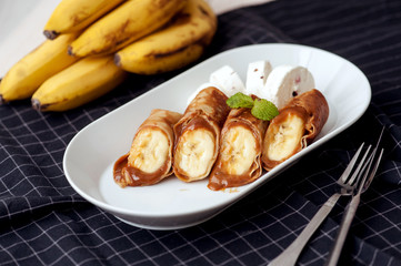 Caramel banana wrapped in a pancake with a sauce