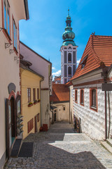 Cesky Krumlov city view in middle of the sunny day thru little alley in town