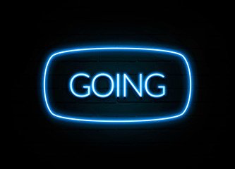 Going  - colorful Neon Sign on brickwall