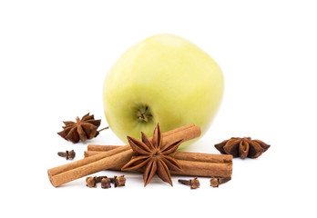 Aromatic apple, star anise, cloves and cinnamon isolated on white background