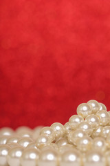 Pile of pearls on red christmas background