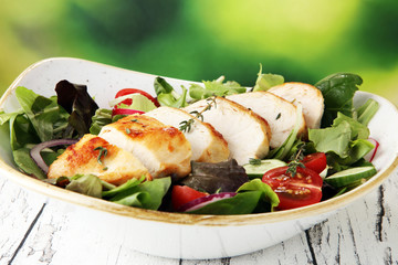 Chicken salad with leaf vegetables and cherry tomatoes.
