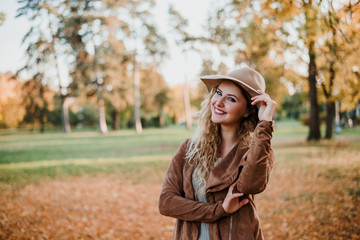 Portrait of fashion blogger girl posing in autumn park.