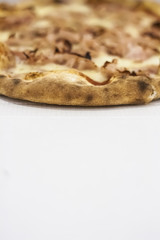Italian wood-burning ham pizza on paper box. Blurred photo, selective focus, perfect as background. Empty space for copy.