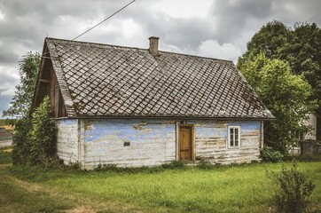Fototapeta na wymiar Beautiful rural scenery in vintage style. Old wooden house in the countryside.