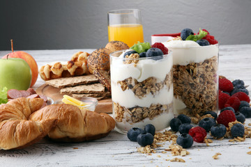 Breakfast served with coffee, orange juice, bread, parfaits and fruits. Balanced diet