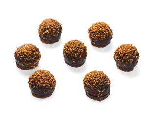 Chocolate dessert with caramel and peanut filling isolated on white background