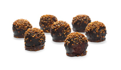 Chocolate dessert with caramel and peanut filling isolated on white background