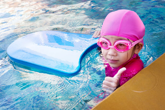 Cute little girl learning to swim