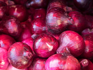 A lot of fresh red onions for sale in the peasant market