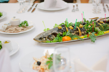 Big fish on table during catering event. Catering buffet.