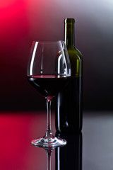 Glass and bottle of red wine.