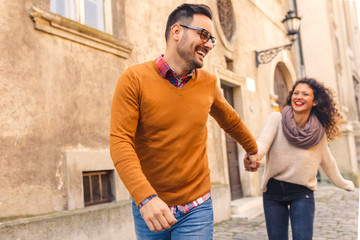 Happy young couple in love having fun on sunny autumn day.