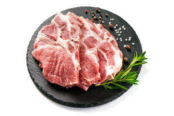 Raw sliced pork meat on stone board, isolated on white background