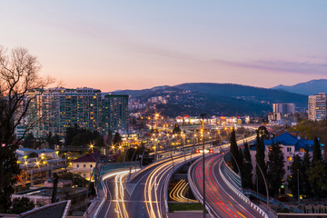 Fototapeta premium Beautiful aerial view of city, mountains and highway 