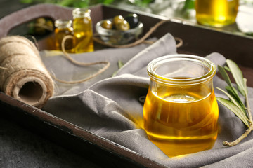 Jar with olive oil on tray