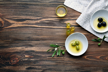 Bowls with olive oil on wooden table