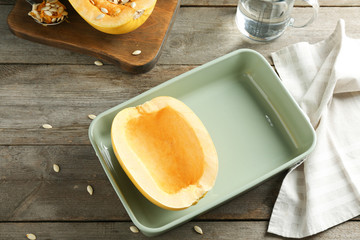 Cut spaghetti squash in baking dish on table