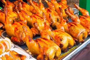 Naklejka premium Roasting Chicken on charcoal , Thai street food market