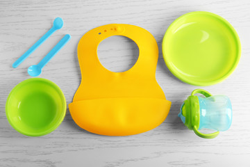 Set with bright baby dishware on table