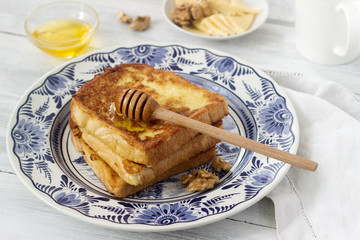 French toast served with honey, nuts and cheese.