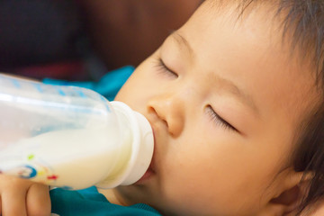 Sleeping baby on bottle feeding.Close up.
