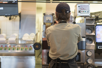 cook in a cafe preparing an order