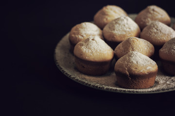 Tasty vanilla muffins on an ornamented plate