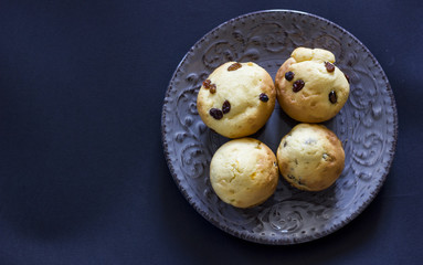 Tasty vanilla muffins on an ornamented plate