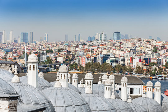 Panoramic view of Istanbul with the domes and chimneys of the Suleymaniye mosque at foreground at sunny day