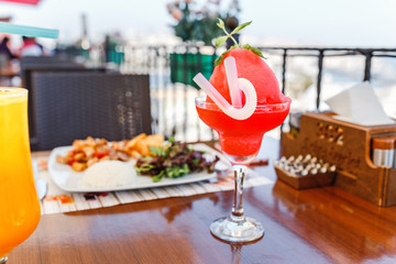 Watermelon drink in glass in city cafe or restaurant