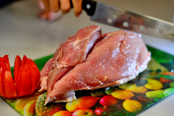 Raw pork on cutting board and vegetables