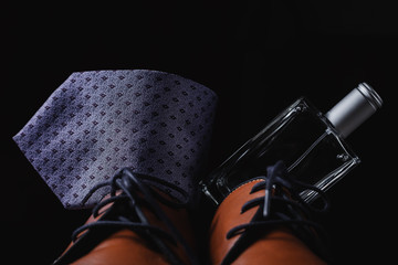 Man's style. shoes with tie and perfume