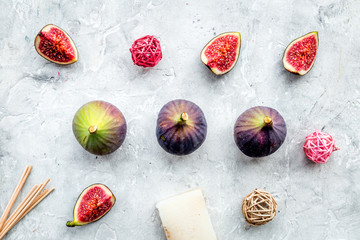 homemade spa with fig cosmetic for bath stone desk background top view