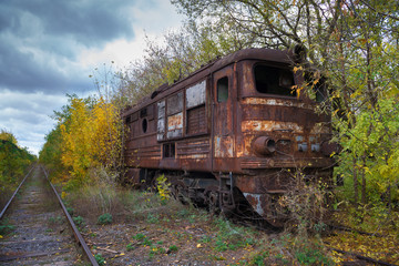 Fototapeta na wymiar Hopeless post apocalyptic landscape. Cemetery of abandoned broken trains.
