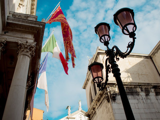 Fototapeta na wymiar Venice, Lamp post flags.