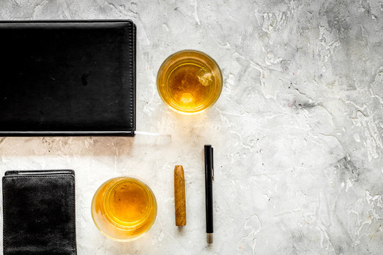 men evening in bar with whiskey, cigar, wallet and notebook on stone bar background top view space for text